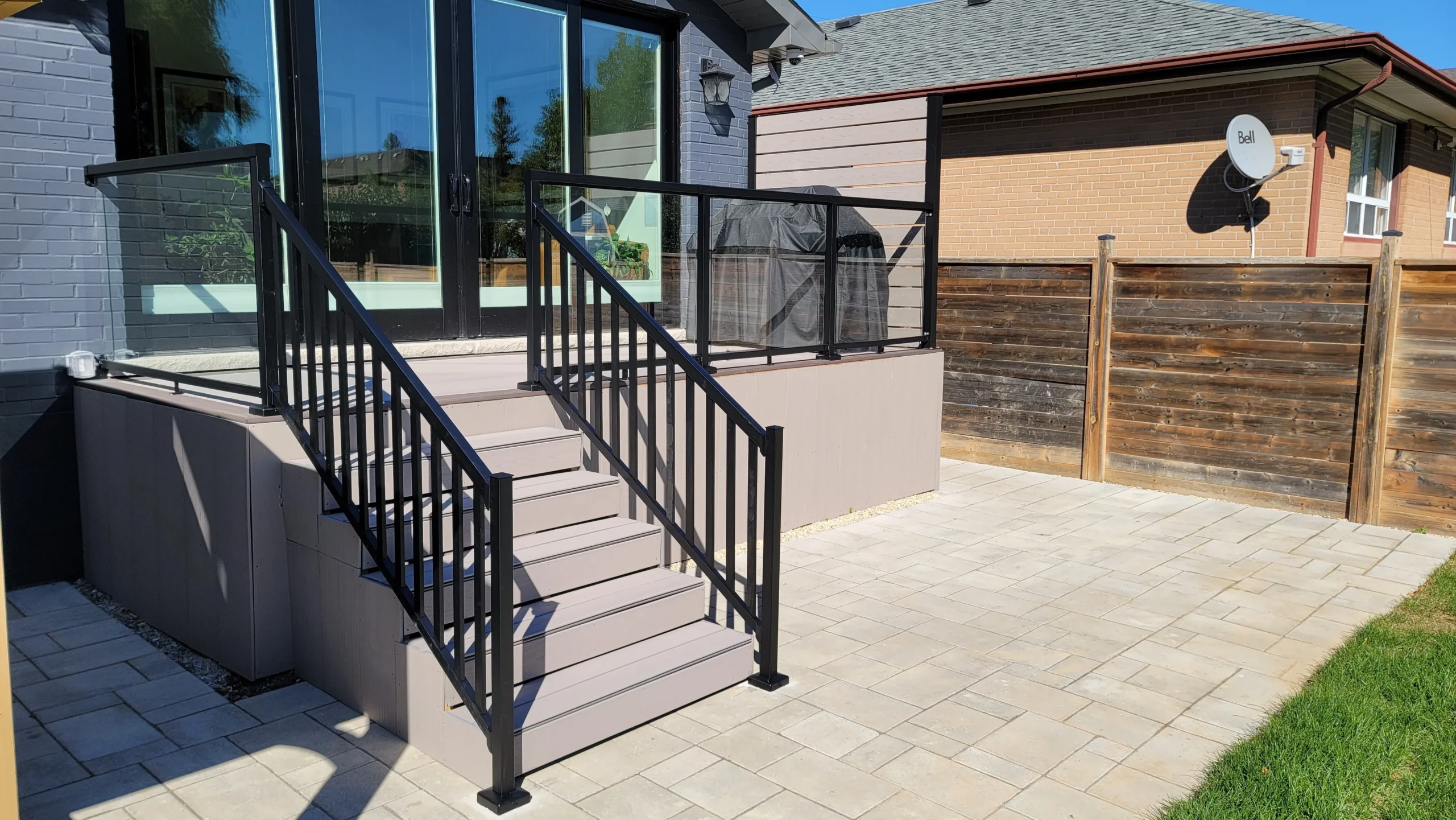 Garden Suites Toronto - Backyard deck patio renovation in Toronto featuring modern steps with railing