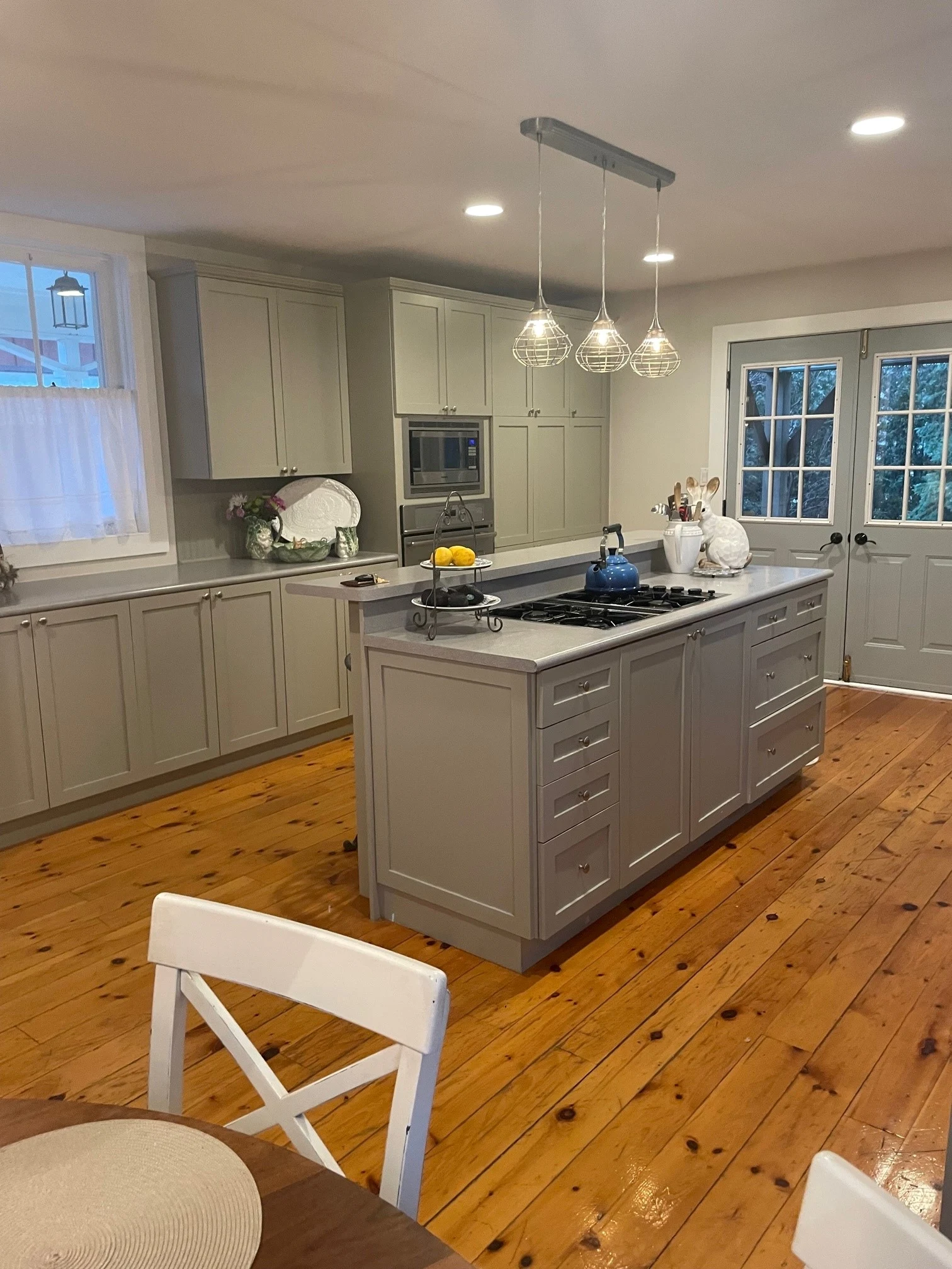 Kitchen renovation in Toronto with custom cabinets, large island, modern lighting, and premium countertop finish
