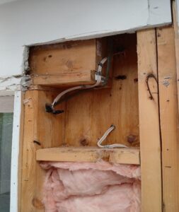 A picture of dangerous electrical work performed by an unlicensed electrician.